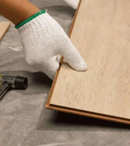 Flooring installer fitting wood-look vinyl planks during installation